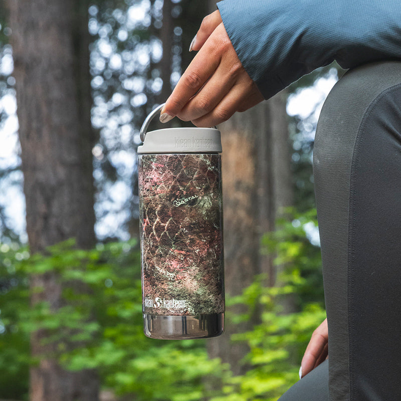12oz-tkwide-with-twist-cap-mossy-oak-a4 12oz_tumbler_mossyoak_rainbowtrout_hand_closeup_square.jpg
