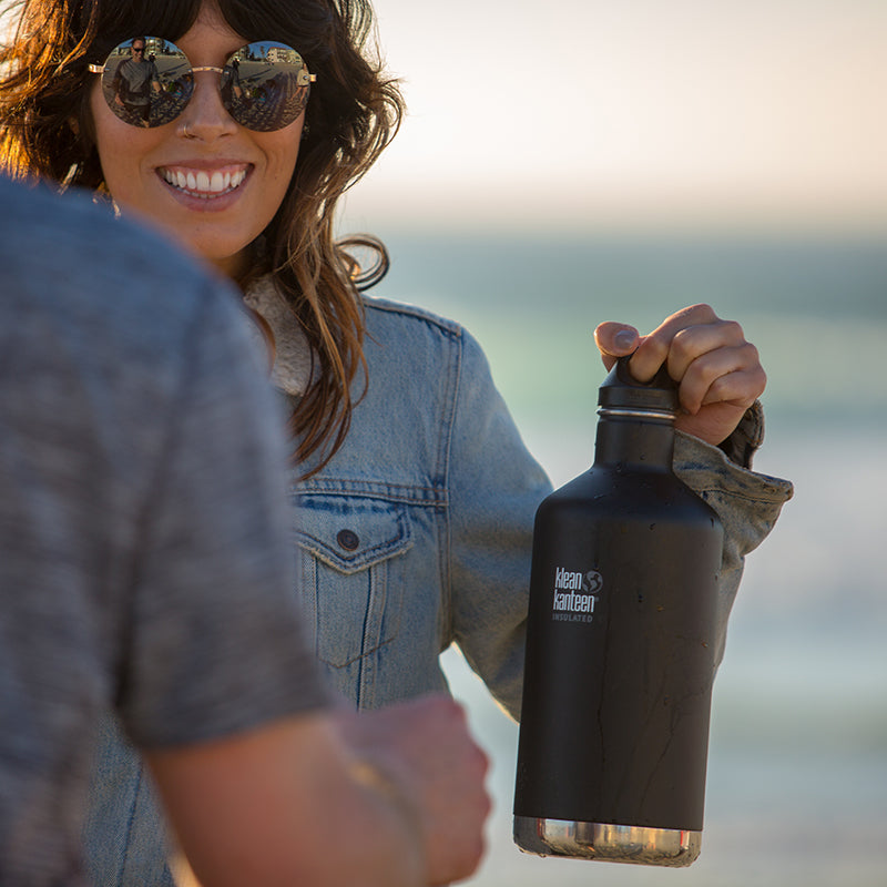 64oz-classic-with-loop-cap-q5 64oz_insulated_classic_black_beach_girl_hand_square.jpg