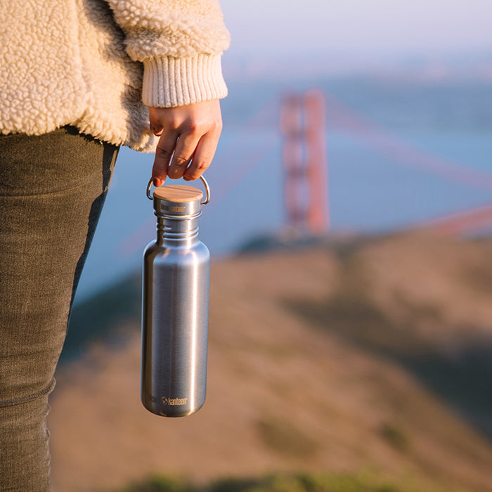 27oz-reflect-with-bamboo-cap-v8 K27SSLRF-BS-BAMBOO_reflect_bottle_bridge_lifestyle.jpg